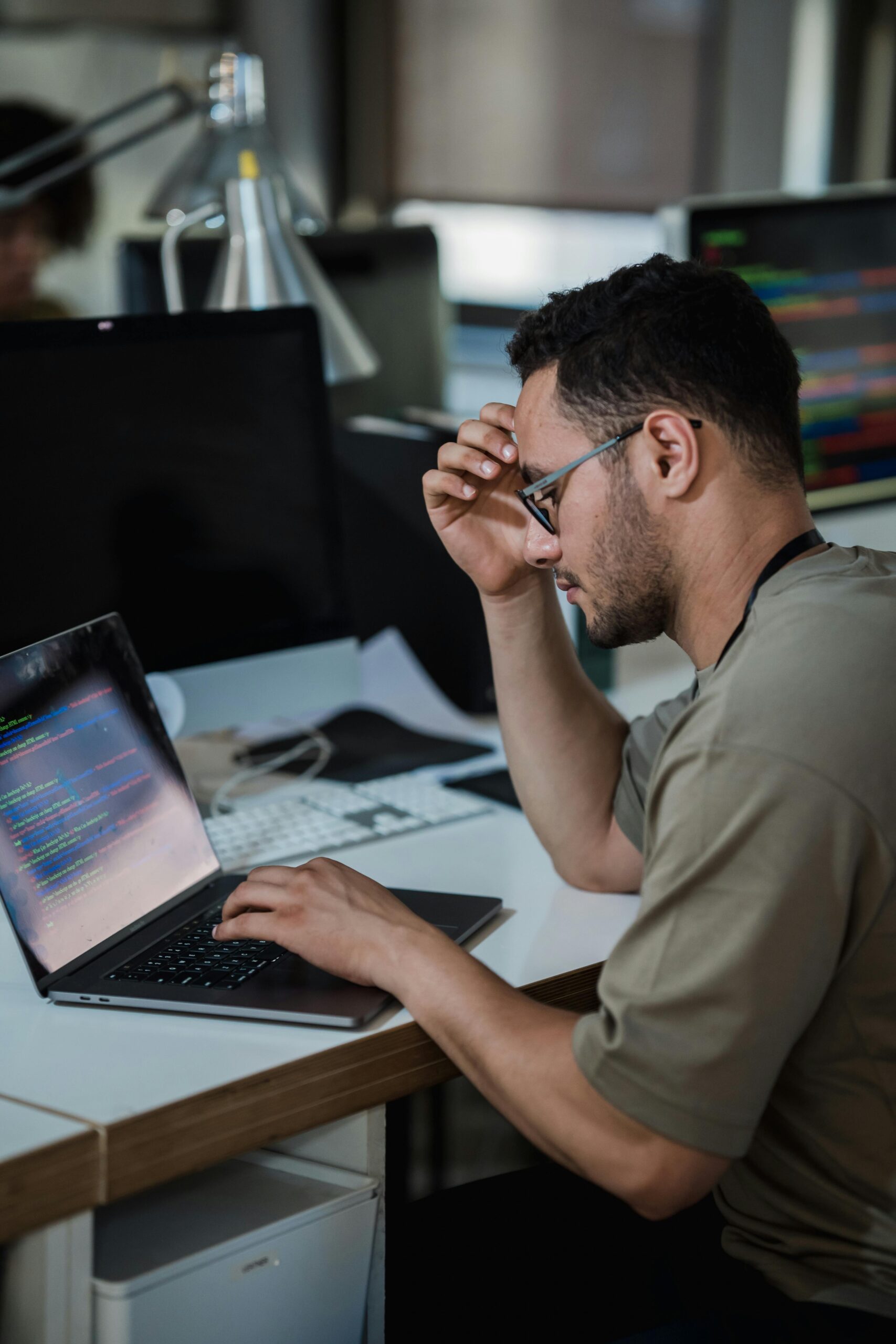 A person working on a laptop in an office